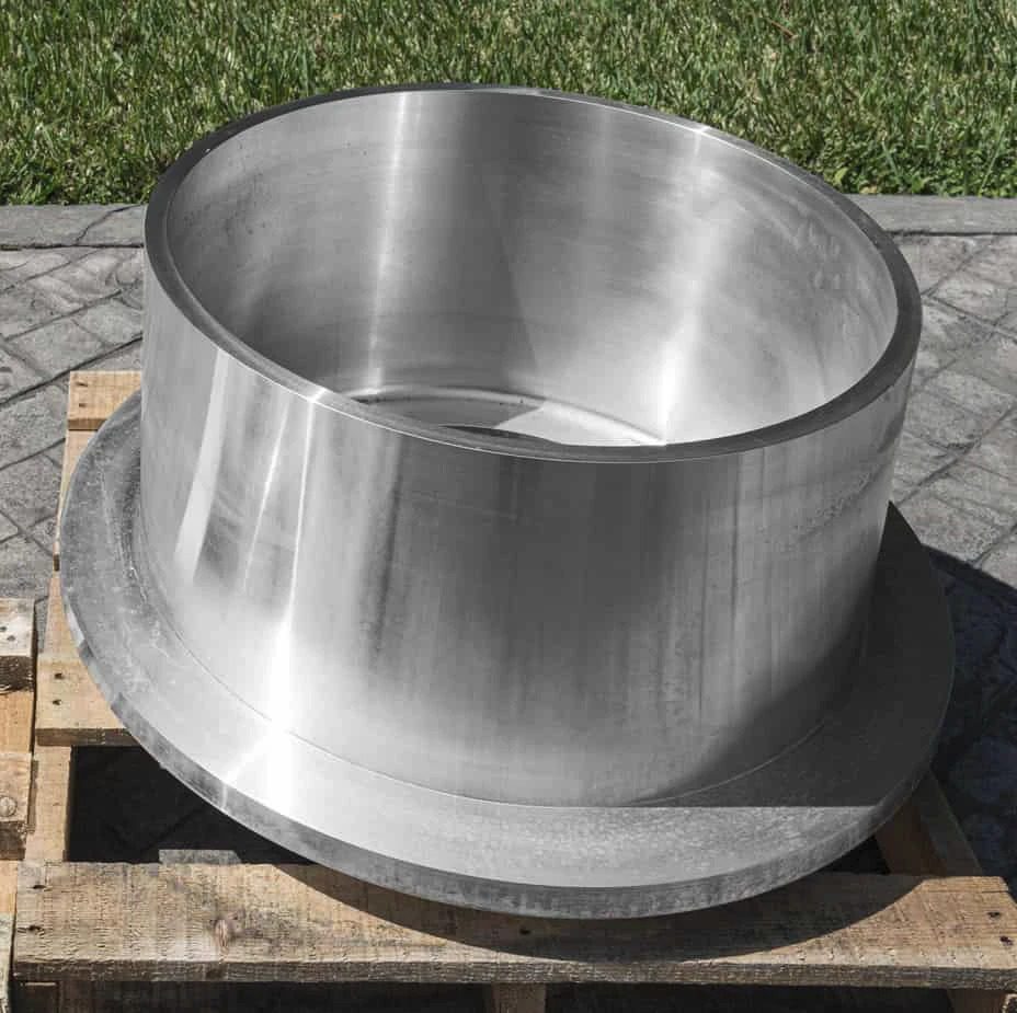 A large stainless steel pot sitting on a pallet.