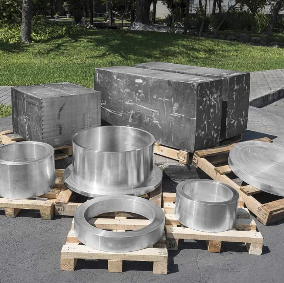 A group of stainless steel pots and pans on a pallet.