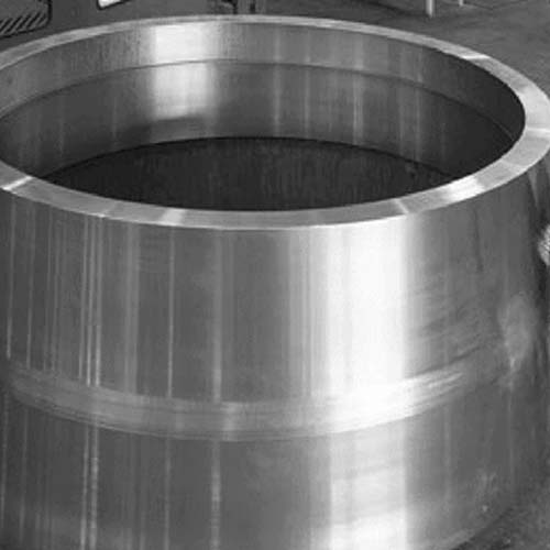 A large stainless steel cylinder in a factory.