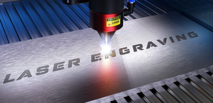 A laser engraving machine is being used to engrave a piece of metal.
