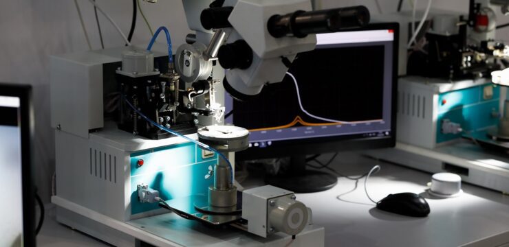 A group of monitors and microscopes in a laboratory.