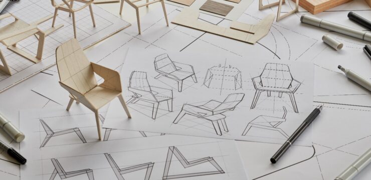 A drawing of a chair on a table with pens and pencils.