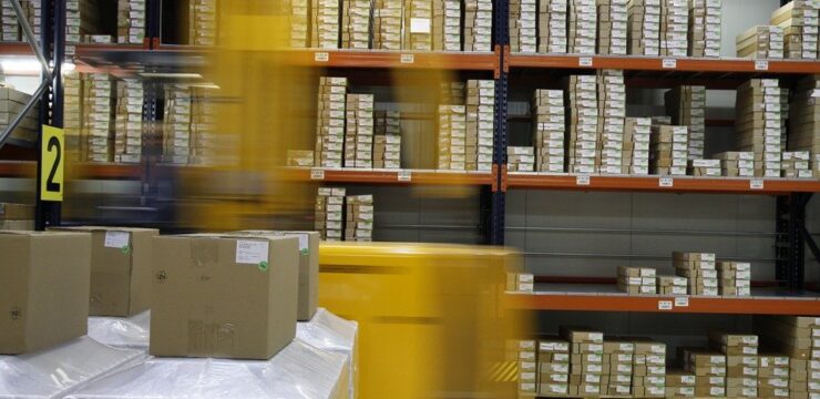 A forklift is moving boxes in a warehouse.