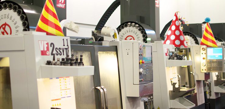 A line of machines in a factory with party hats on them.