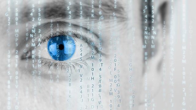 A man's eye with a binary code in front of it.