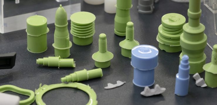 A group of green plastic parts on a table.