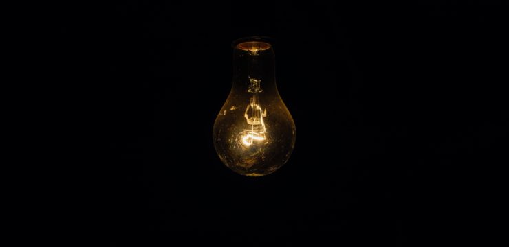 A light bulb on a black background.