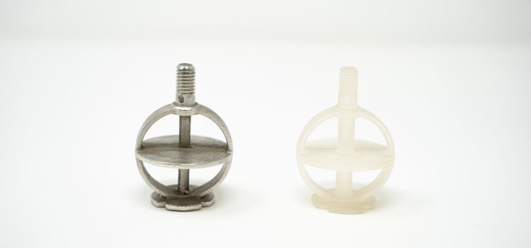 A pair of small metal objects on a white surface.
