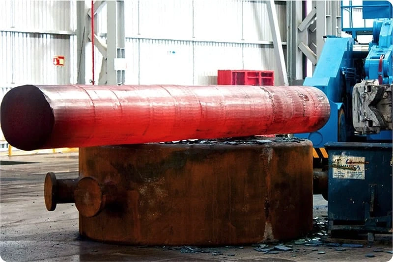 A large red pipe sitting on top of a machine.