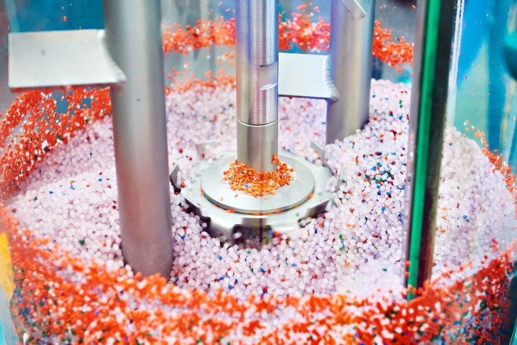 A machine filled with colorful sprinkles in a factory.